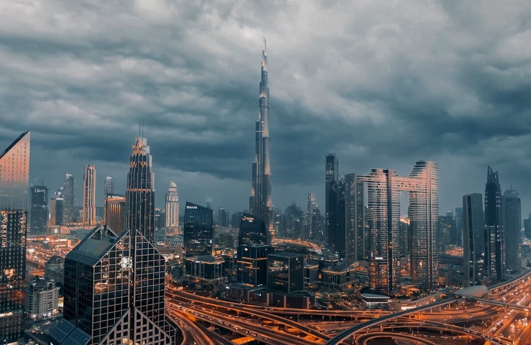 The Burj Khalifa rising above the skyline of Downtown Dubai under dark storm clouds